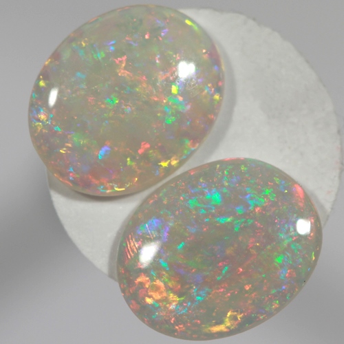SOLID SEMI BLACK OPALS Matching pair, bright multicolours